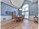 Dining room features hardwood floors, large window, stylish light fixture, and decorative accent wall at 329 Lakebridge Xing, Canton, GA 30114