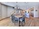 Dining area showcases hardwood floors open to kitchen, with adjacent staircase and modern light fixture at 329 Lakebridge Xing, Canton, GA 30114