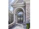 Elegant entryway with arched doorway, double doors, and manicured landscaping creating a welcoming entrance at 329 Lakebridge Xing, Canton, GA 30114