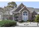 Charming brick and stucco home with an arched window, double front doors with wreath decorations at 329 Lakebridge Xing, Canton, GA 30114
