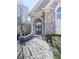 Elegant entryway with arched doorway, double doors, and manicured landscaping creating a welcoming entrance at 329 Lakebridge Xing, Canton, GA 30114