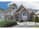 Charming brick and stucco home with an arched window, double front doors with wreath decorations at 329 Lakebridge Xing, Canton, GA 30114