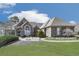 Beautiful one-story home featuring brick exterior, arched entry, manicured lawn and landscaping at 329 Lakebridge Xing, Canton, GA 30114