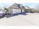 A spacious driveway leads to the three-car garage of this brick home at 329 Lakebridge Xing, Canton, GA 30114