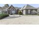 Well-manicured lawn, decorative shrubs, and stone walkway enhance the curb appeal of this brick home at 329 Lakebridge Xing, Canton, GA 30114