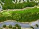 Aerial view of a golf course featuring lush green fairways, sand traps, and a winding path at 329 Lakebridge Xing, Canton, GA 30114