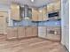 Close-up of kitchen featuring hardwood floors, stainless steel appliances, custom cabinetry and bar height counter at 329 Lakebridge Xing, Canton, GA 30114