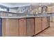 Kitchen boasts granite countertops, stainless steel dishwasher, sink, and custom cabinets, complemented by wood flooring at 329 Lakebridge Xing, Canton, GA 30114