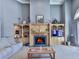 Inviting living room with a fireplace, custom shelving, and ample natural light, perfect for relaxing and entertaining at 329 Lakebridge Xing, Canton, GA 30114