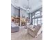 Spacious living room with soaring ceilings, a cozy fireplace, built-in shelving, and large windows for natural light at 329 Lakebridge Xing, Canton, GA 30114
