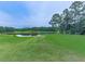 Scenic pond surrounded by lush greenery, offering a peaceful natural view at 329 Lakebridge Xing, Canton, GA 30114