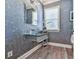 Modern powder room features a glass sink, elegant fixtures, and hardwood floors at 329 Lakebridge Xing, Canton, GA 30114