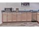 Basement wet bar with light wood cabinets, microwave, sink, and stainless beverage fridge at 329 Lakebridge Xing, Canton, GA 30114