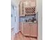 Charming wet bar area boasts custom wood cabinets, a wine rack, and attractive granite countertops at 329 Lakebridge Xing, Canton, GA 30114