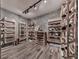 Custom wine cellar features wooden wine racks against grey stone-look wall at 329 Lakebridge Xing, Canton, GA 30114