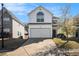 Two-story home with white siding, attached garage, and concrete driveway at 5636 One Lake Way, College Park, GA 30349