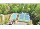 Aerial view of community pool, tennis courts, and clubhouse surrounded by lush trees at 5819 Rue Chase Way, Tucker, GA 30084