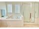 Elegant bathroom with a glass-enclosed shower and soaking tub at 5819 Rue Chase Way, Tucker, GA 30084