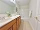 Bathroom featuring a double vanity and a shower-tub combination with white tile surround at 5819 Rue Chase Way, Tucker, GA 30084