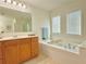 Bathroom with a luxurious soaking tub and double window at 5819 Rue Chase Way, Tucker, GA 30084