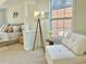 Bedroom area with seating next to the window with natural light at 5819 Rue Chase Way, Tucker, GA 30084