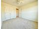 Bedroom featuring neutral carpet, ceiling fan, double closets and access to another room at 5819 Rue Chase Way, Tucker, GA 30084