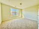 Bright bedroom featuring neutral carpeting, large window, and plenty of natural light at 5819 Rue Chase Way, Tucker, GA 30084