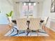 Elegant dining table with tufted chairs, set on a patterned rug at 5819 Rue Chase Way, Tucker, GA 30084