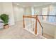 Upstairs hallway featuring cozy carpet and a view to rooms beyond at 5819 Rue Chase Way, Tucker, GA 30084