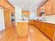 Spacious kitchen features wood cabinets, stainless steel appliances, and a center island at 5819 Rue Chase Way, Tucker, GA 30084