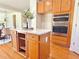 Spacious kitchen island with seating and wooden cabinets and view of appliances at 5819 Rue Chase Way, Tucker, GA 30084