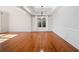 Spacious living room featuring hardwood flooring, paneled walls, and a tray ceiling at 5819 Rue Chase Way, Tucker, GA 30084