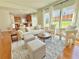 Comfortable living room with large windows, light hardwood floors, and an open concept at 5819 Rue Chase Way, Tucker, GA 30084
