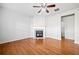 Bright living room with hardwood floors, a ceiling fan, and a modern fireplace at 5819 Rue Chase Way, Tucker, GA 30084