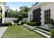 Charming backyard with manicured hedges, water feature and access door to the main house at 90 Polo Ne Dr, Atlanta, GA 30309