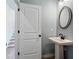 Stylish powder room featuring a pedestal sink, modern fixtures, and a well-lit mirror at 146 Silver Leaf Trce, Douglasville, GA 30134