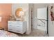 A bedroom with peach colored accent wall, decor, and a view of the hallway with wooden banister at 146 Silver Leaf Trce, Douglasville, GA 30134