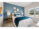 A bedroom featuring a wood accent wall, plush bedding, and a window that brings in natural light at 146 Silver Leaf Trce, Douglasville, GA 30134