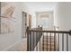 Upstairs hallway with art, black railing and view to bedrooms at 146 Silver Leaf Trce, Douglasville, GA 30134