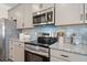 A close-up of a modern kitchen featuring stainless steel appliances and granite countertops at 146 Silver Leaf Trce, Douglasville, GA 30134