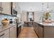 Modern kitchen featuring granite countertops, stainless steel appliances, and an open layout to the dining area at 146 Silver Leaf Trce, Douglasville, GA 30134