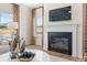 Cozy living room with a fireplace, mantle mounted television, designer decor, and bright, natural lighting at 146 Silver Leaf Trce, Douglasville, GA 30134