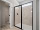 Sleek walk-in shower boasts a frameless glass enclosure and modern fixtures for a spa-like experience at 146 Silver Leaf Trce, Douglasville, GA 30134