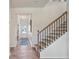 Staircase with hardwood steps, and a view into the entryway and front door at 146 Silver Leaf Trce, Douglasville, GA 30134