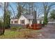 Charming home with wood accents and a brick chimney, complemented by a quaint porch and surrounding greenery at 1849 S Columbia Place, Decatur, GA 30032