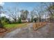 Quaint home with inviting driveway and ample parking space, surrounded by mature trees and greenery at 1849 S Columbia Place, Decatur, GA 30032