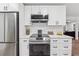 Kitchen features stainless steel appliances, white cabinets, and modern countertops at 1849 S Columbia Place, Decatur, GA 30032