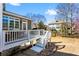 Home's rear deck with white railings overlooks a spacious backyard with mature trees at 4048 Sandy Branch Ne Dr, Buford, GA 30519