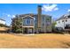 The rear of this large home shows a large backyard with the covered patio visible at 4048 Sandy Branch Ne Dr, Buford, GA 30519