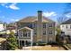 Picture of the rear exterior featuring large windows for plenty of natural light and a brick chimney at 4048 Sandy Branch Ne Dr, Buford, GA 30519